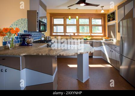 Straight on view of kitchen with irregularly shaped granite counter Stock Photo