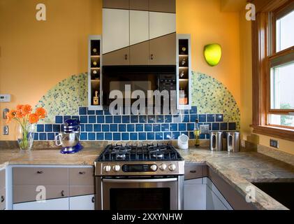 View of kitchen showing stove and colorful design of tile backsplash Stock Photo