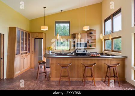 Full view of warm sunny kitchen with lots of windows in passive solar house Stock Photo