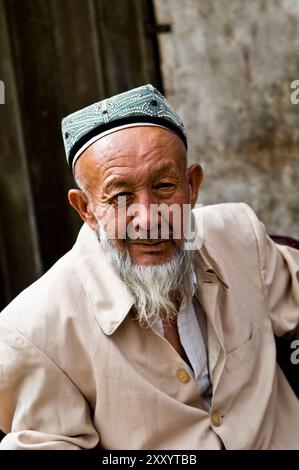 Portrait of an Uyghur man taken in the old city of Kashgar, Xinjiang, China. Stock Photo