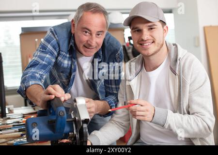 carpenter with apprentice in training period Stock Photo
