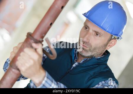 technician checking the state of metal pipes indoors Stock Photo