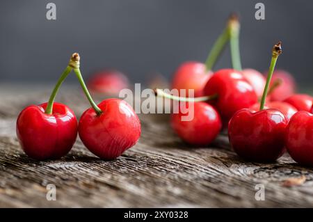 Fresh ripe red cherries in bowl on white stone background, heap of summer fruits concept Stock Photo