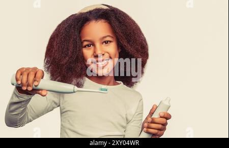 Healthy teeth, toothpaste. Small girl, toothbrush. Little cute african american girl brushing her teeth. Stock Photo