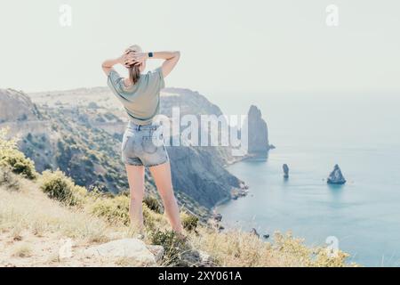 A Woman Admiring the View of a Rocky Coastline Stock Photo