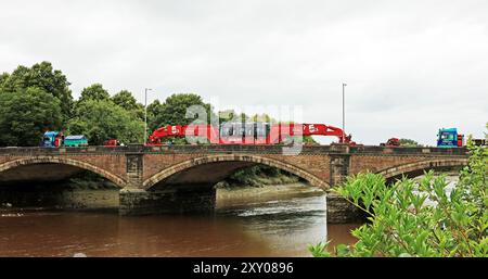 Alleys heavy haulage team are moving a large electrical transformer across the River Ribble on Liverpool Road from the docks at Preston to Penwortham Stock Photo