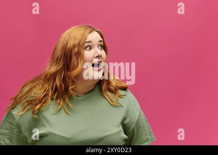 A woman with red hair and a surprised expression looks to her left. Stock Photo