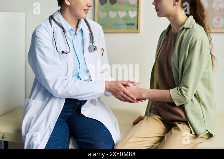 Doctor speaking with patient in clinical office, both individuals seated as they talk about treatment options, patient wearing casual clothes while doctor in white coat Stock Photo