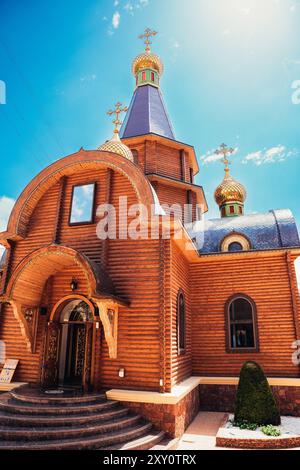 View of an ornate orthodox Catholic church located in Altea, Valencia, showcasing its unique wooden architecture and decorative golden domes against a Stock Photo