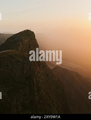A majestic sunset view in Lanzarote, showing the vast volcanic landscape under a warm, bright sky Stock Photo
