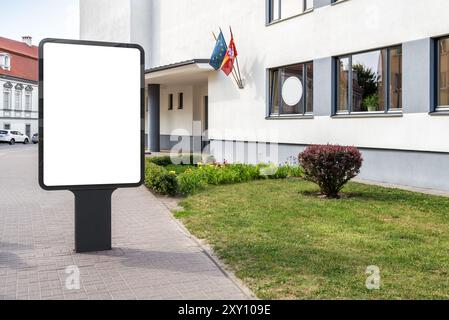 Blank Mockup Of Vertical Street Billboard On The Sidewalk. Advertising Poster Lightbox Next To High School Stock Photo