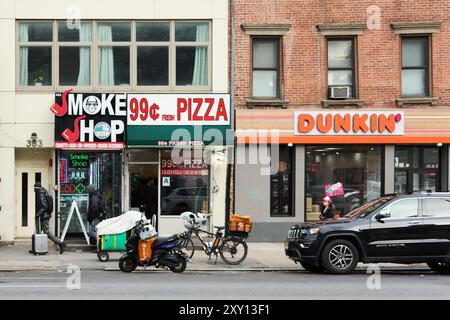 New York, United States - August 27, 2024: 99-cent pizza storefront and Dunkin in NYC Stock Photo