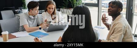 Four individuals collaborate around a table, engaged in a lively discussion. Stock Photo