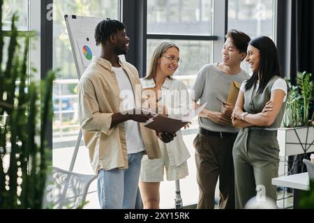 A diverse group of four individuals discuss ideas in a modern office setting. Stock Photo