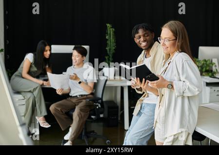 A diverse team collaborates in a contemporary office setting, brainstorming ideas for a new venture. Stock Photo