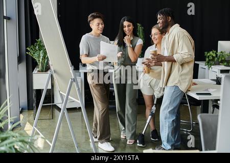 A group of colleagues collaborates on a project, reviewing documents and brainstorming. Stock Photo