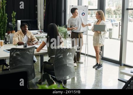 A diverse startup team collaborates in a modern office. Stock Photo