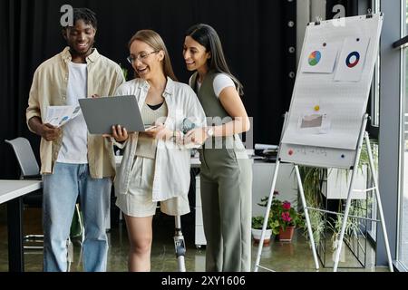 A diverse group of coworkers collaborate in a modern office, reviewing plans and charts. Stock Photo