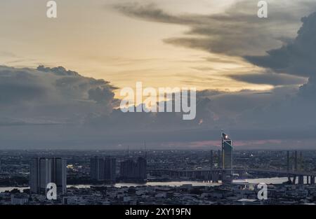 Bangkok, Thailand - 22 Aug 2024 - Beautiful skyscrapers view and the Bridge crosses the Chao Phraya river of Bangkok city with Dramatic sky background Stock Photo