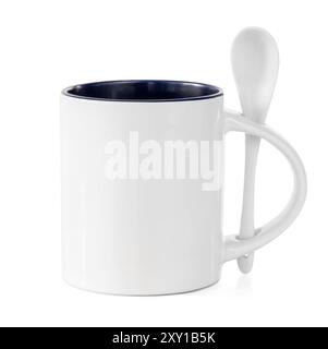 White cup with colored mid with white teaspoon isolated on a white background Stock Photo