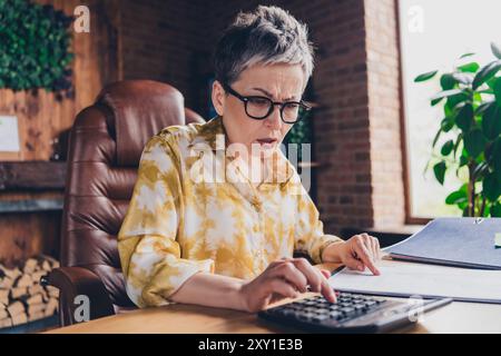 Photo of attractive successful serious woman assistant economist doing weekly report indoors workstation workspace Stock Photo
