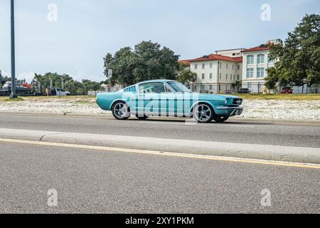 Gulfport, MS - October 05, 2023: Wide angle side view of a 1965 Ford Mustang Fastback Coupe at a local car show. Stock Photo