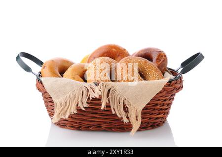 A basket of fresh baked bagels. Horizontal format isolated on white with reflection. Stock Photo