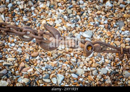 A rusty metal tow hook with chains and wire rope. Stock Photo