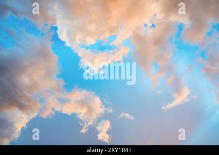 Beautiful dramatic orange clouds on blue sky in the evening Stock Photo
