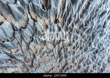 Abstract weathered rocky limestone mountain cave with lichen surface natural background Stock Photo