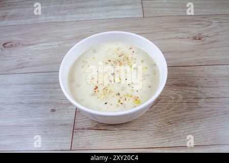 Sweet Rabdi or Lachha Rabri or basundi, made with pure milk garnished with dry fruits. Served in a bowl over moody background. Selective focus Stock Photo