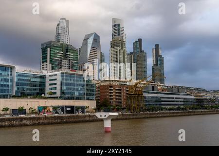 The skyline of Puerto Madero over Dock 3 in Buenos Aires, Argentina, including the Alvear Tower, tallest building in Argentina.  Also shown are the Mu Stock Photo