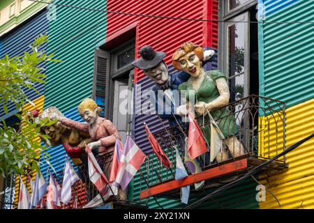 Caricature statues of people on balconies on a colorfully-painted building in Caminito, La Boca, Buenos Aires, Argentina.  Evita or Eva Peron is depic Stock Photo