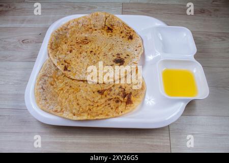 Puran Poli, also known as Holige, is an Indian sweet flatbread from India consumed mostly during Holi festival. Served in a plate with pure Ghee. Stock Photo