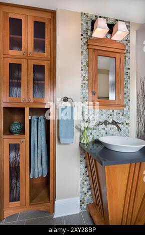 Bathroom with custom vanity and glass tile backsplash and custom storage cabinet Stock Photo