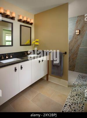 Modern bathroom with double vanity and mix of tiles on floor and walls Stock Photo