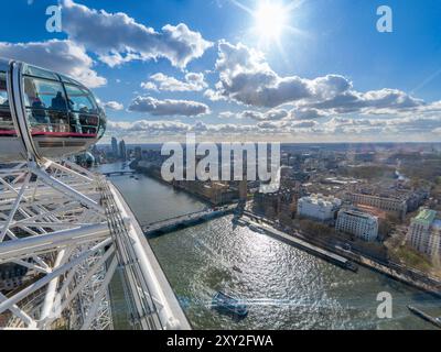 Aerial view of the River Thames, Westminster Abbey and Big Ben from the London Eye with tourists looking at the landscape and taking photos. Stock Photo