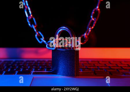 Padlock with chain on laptop, closeup. Cyber security concept Stock Photo