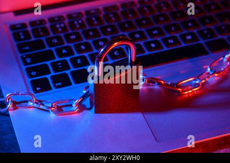 Padlock with chain on laptop, closeup. Cyber security concept Stock Photo