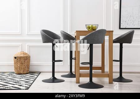 Bar stools near table in stylish room Stock Photo