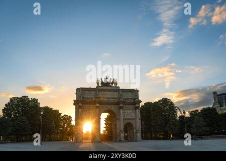 Sunset Through Arc de Triomphe du Carrousel - Paris, France Stock Photo