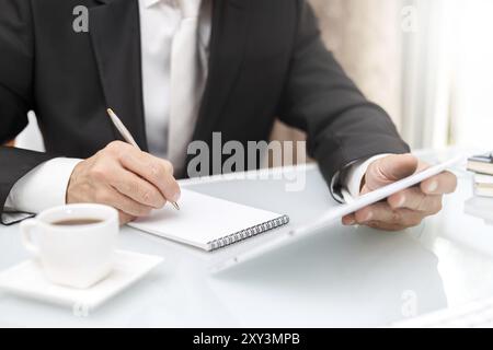 Male hands using modern tablet and writing with pen business concept Stock Photo