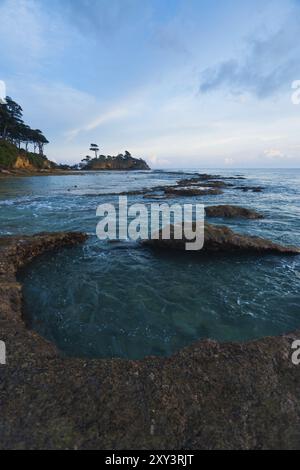 Calm turquoise water fills a series of natural tide pools in a beautiful coastal landscape of Neil Island of the Andaman and Nicobar Islands of India Stock Photo