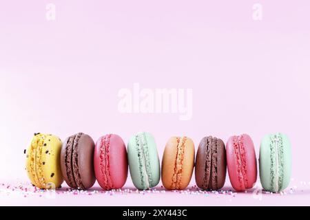 Colorful french macarons on pink background traditioanal desert in France Stock Photo