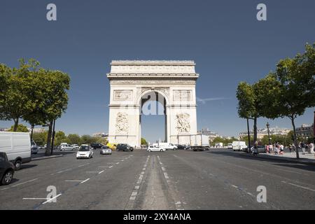 A view down Champs Elysees avenue at the centered iconic Arc De Triomphe in Paris, France. Horizontal Stock Photo