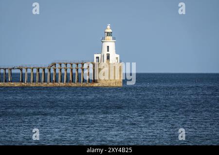 Blyth Lighthouse and the pier on the North Sea Coast, seen on South Beach in Blyth, England, UK Stock Photo