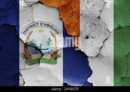 Flags of Abidjan and Ivory Coast painted on cracked wall Stock Photo