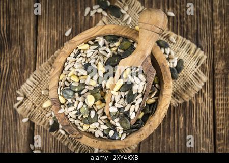 Portion of mixed Seeds (close-up shot, selective focus) on wooden background Stock Photo