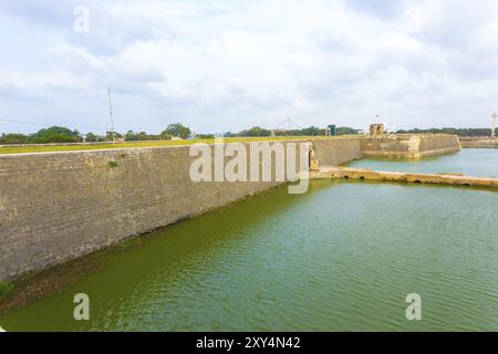 Distant view of entrance and bridge over moat into Jaffna Fort in Sri Lanka. Horizontal Stock Photo