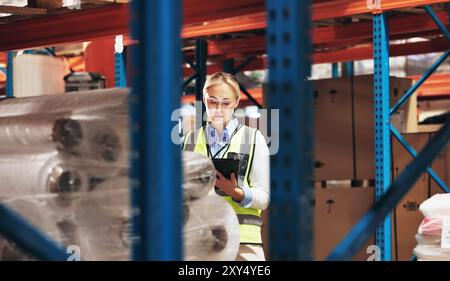 Woman, supplier and inventory with tablet in logistics for quality control or checking stock at warehouse. Young female person, distributor or manager Stock Photo